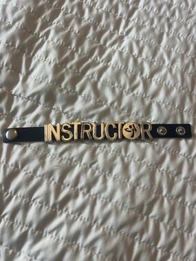 Zumba Fitness Black Bracelet with silver 'INSTRUCTOR' Lettering. Has some wear